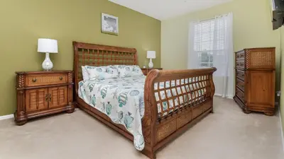 a bedroom with a wooden bed and a night stand at Urban 3 Bed 2 Bath Condo- Perfect stay while exploring Orlando,Florida in Orlando