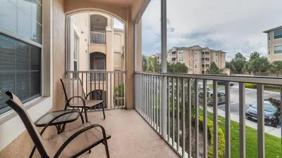 a balcony with chairs and a view of a street at Urban 3 Bed 2 Bath Condo- Perfect stay while exploring Orlando,Florida in Orlando