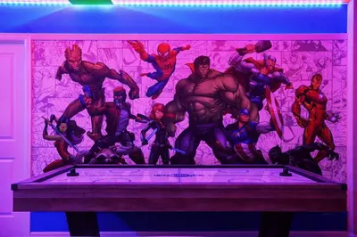 a group of superheroes painted on a wall at Mansão 9 Quartos com Cinema, Piscina e SPA in Kissimmee