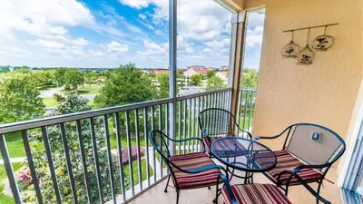 a balcony with two chairs and a table on a balcony at Private 3 Bed 2 Bath House - Cozy family vacation home sleeps up to 6 guests in Orlando