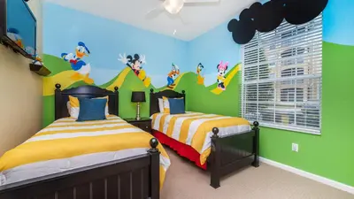 a bedroom with two beds and a green wall at Contemporary 3 Bed 2 Bath Condo- Near Walt Disney World W/ great amenities in Orlando