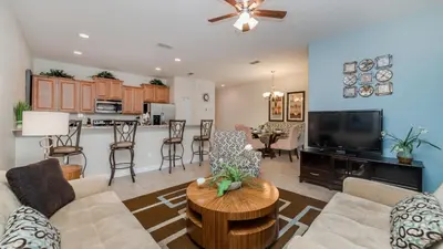 a living room with a couch and a table at Contemporary 4 Bed 3 Bath Townhome - Near Walt Disney World W/ great amenities in Kissimmee