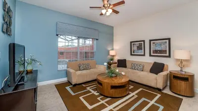 a living room with a couch and a tv at Contemporary 4 Bed 3 Bath Townhome - Near Walt Disney World W/ great amenities in Kissimmee