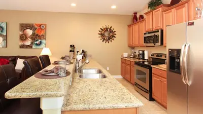 a kitchen with a sink and a counter top at Contemporary 4 Bed 3 Bath Townhome - Near Walt Disney World W/ great amenities in Kissimmee