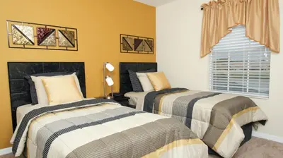 two beds in a bedroom with yellow walls at Contemporary 4 Bed 3 Bath Townhome - Near Walt Disney World W/ great amenities in Kissimmee