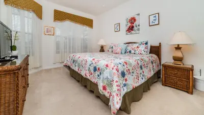 a bedroom with a bed and a tv and windows at Urban 5 Bed 5 Bath Villa - Perfect stay while exploring Orlando,Florida in Orlando