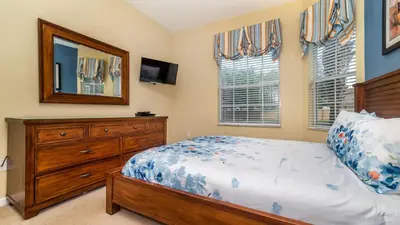 a bedroom with a bed and a dresser and a mirror at GRH9185 - Windsor Hills Resort - 3 Bed 2 Baths Condo in Orlando