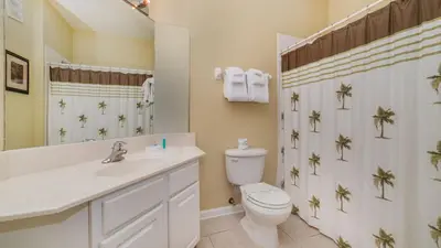 a bathroom with a toilet and a sink and a mirror at GRH9185 - Windsor Hills Resort - 3 Bed 2 Baths Condo in Orlando