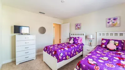 a bedroom with a purple bed and a dresser at GRH9244 - Storey Lake Resort - 5 Bed 4 Baths Townhome in Kissimmee