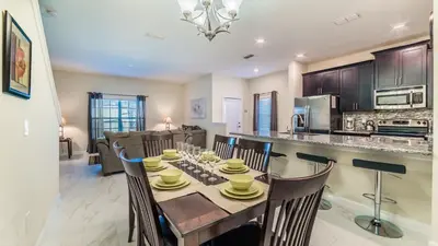 a dining room and kitchen with a table and chairs at GRH9244 - Storey Lake Resort - 5 Bed 4 Baths Townhome in Kissimmee