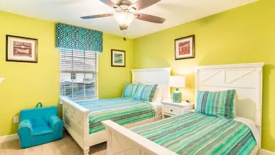 a bedroom with two beds and a ceiling fan at GRH9245 - Storey Lake Resort - 4 Bed 3 Baths Townhome in Kissimmee