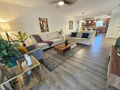 a living room with a couch and a table at Bungalow DT by Lake Eola KIA center Sleeps 12 in Orlando