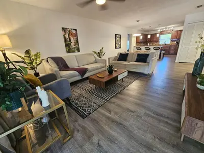 a living room with a couch and a table at Bungalow DT by Lake Eola KIA center Sleeps 12 in Orlando