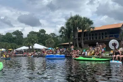 a group of people sitting on canoes in the water at Bungalow DT by Lake Eola KIA center Sleeps 12 in Orlando