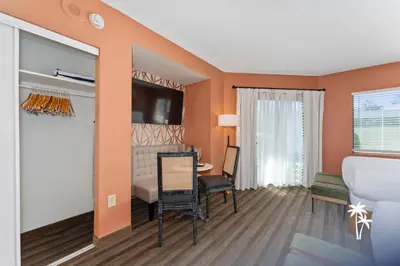 a living room with a table and a dining room at Boho Chic Garden Condo 7 Min to Universal Parks in Orlando