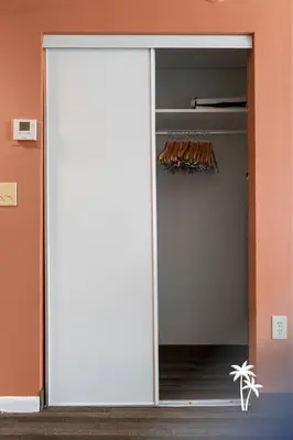 a sliding glass door leading into a closet at Boho Chic Garden Condo 7 Min to Universal Parks in Orlando