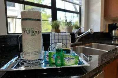a kitchen sink with a roll of paper towels and cleaning products at Perfect Summer Escape - Townhome by Disney in Orlando