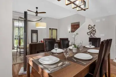 a dining room with a wooden table with chairs at Perfect Summer Escape - Townhome by Disney in Orlando