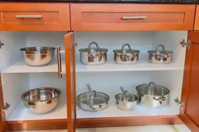 a row of pots on a shelf in a kitchen at Perfect Summer Escape - Townhome by Disney in Orlando