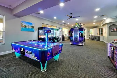 a room with two arcade games and a video game at Windsor Hills Resort - Water Park - Private Heated Plunge Pool - Near Disney in Orlando