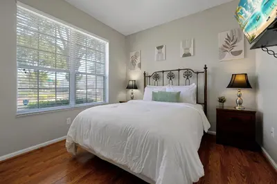 a bedroom with a white bed and a window at Windsor Hills Resort - Water Park - Private Heated Plunge Pool - Near Disney in Orlando