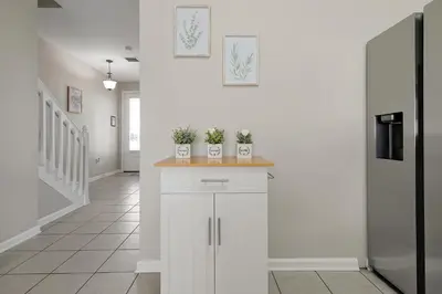 a white kitchen with potted plants on a counter at Windsor Hills Resort - Water Park - Private Heated Plunge Pool - Near Disney in Orlando