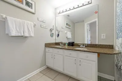a bathroom with a sink and a mirror at Windsor Hills Resort - Water Park - Private Heated Plunge Pool - Near Disney in Orlando