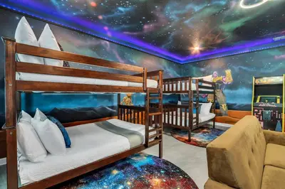 a bedroom with two bunk beds and a mural of the universe at Stunning 7BR Resort Pool Home 13 Min Disney in Kissimmee