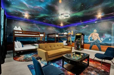 a living room with a room with a mural of the universe at Stunning 7BR Resort Pool Home 13 Min Disney in Kissimmee
