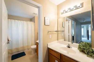 a bathroom with a sink and a toilet and a mirror at Resort Bliss Near Disney Longer Stays Welcome in Kissimmee