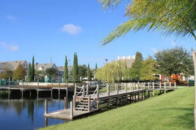 a dock with chairs sitting on it next to the water at Resort Bliss Near Disney Longer Stays Welcome in Kissimmee