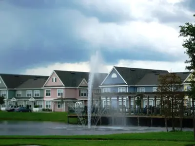 a fountain in a pond in front of a building at Resort Bliss Near Disney Longer Stays Welcome in Kissimmee