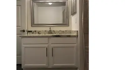 a bathroom with a sink and a mirror at Beautiful Townhome In a Resort Near Disney in Kissimmee