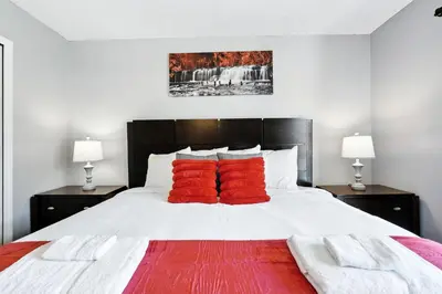 a bedroom with a large bed with red pillows at Family Getaway Near Clubhouse and Community Pool 5 miles from Disney in Kissimmee