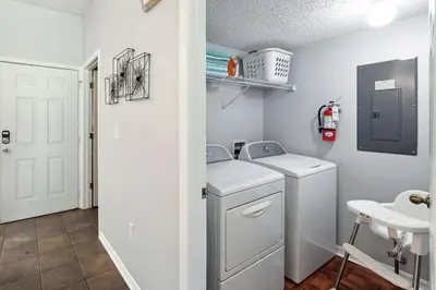 a laundry room with a washer and dryer at Family Getaway Near Clubhouse and Community Pool 5 miles from Disney in Kissimmee