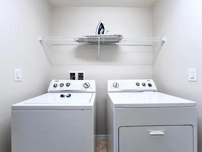 a kitchen with two white washers and a boat on a shelf at Disney Getaway Villa with Private Pool Hot Tub. Book Now VP140 in Kissimmee