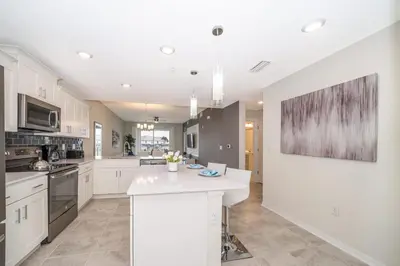 a kitchen with white cabinets and a white counter top at Disney Getaway Luxury Condo with Private Balcony. Book Now SLR366 in Kissimmee