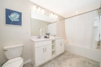 a bathroom with a toilet and a sink and a tub at Disney Getaway Luxury Condo with Private Balcony. Book Now SLR366 in Kissimmee
