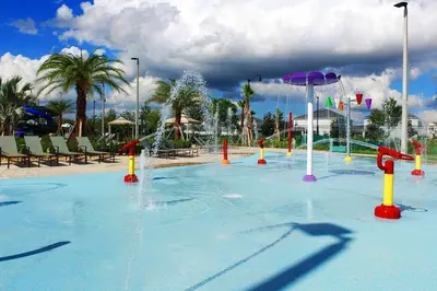 a large swimming pool with a water park at Disney Getaway Luxury Condo with Private Balcony. Book Now SLR366 in Kissimmee