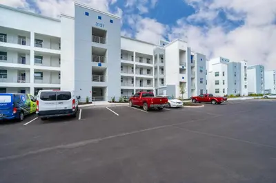 a parking lot in front of a large apartment building at Disney Getaway Luxury Condo with Private Balcony. Book Now SLR366 in Kissimmee