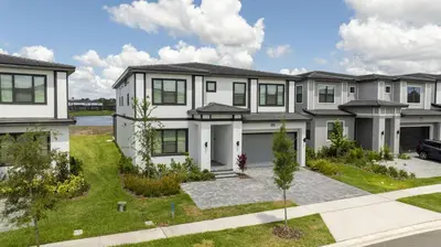 a large white house with a driveway at Disney Private Pool Game Room Themed Bedrooms. Book Now PG25 in Orlando