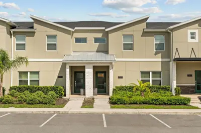 a large apartment building with a parking lot at Disney Getaway Private Pool Themed Bedrooms. Book Now SLR1243 in Kissimmee