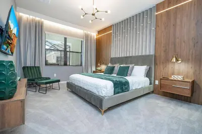 a bedroom with a bed and a desk and a chair at Disney Private Pool Game Room Themed Bedrooms. Book Now PG20 in Orlando