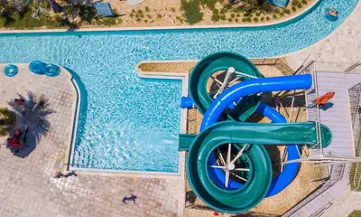 an overhead view of a swimming pool with a water slide at Disney Getaway Townhouse with Private Pool. Book Now SLR484 in Kissimmee
