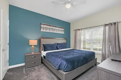 a blue bedroom with a bed and a window at Disney Getaway Private Pool Themed Bedrooms. Book Now SLR1162 in Kissimmee
