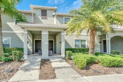 a house with palm trees in front of it at Disney Getaway Private Pool Themed Bedrooms. Book Now SLR1162 in Kissimmee