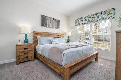 a bedroom with a bed and two lamps and a window at Disney Getaway Private Pool Themed Bedrooms. Book Now SLR410 in Kissimmee