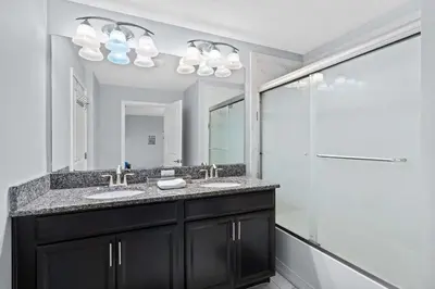 a bathroom with two sinks and a shower at Disney Getaway Townhouse with Private Pool. Book Now SLR476 in Kissimmee
