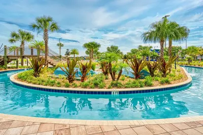 a pool at a resort with palm trees at Disney Getaway Townhouse with Private Pool. Book Now SLR476 in Kissimmee