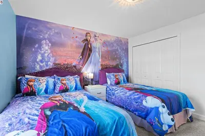 a bedroom with two beds and a painting on the wall at Disney Getaway Private Pool Themed Bedrooms. Book Now SLR481 in Kissimmee